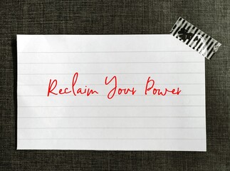 Note stick on wall with handwritten text Reclaim Your Power, self talk affirmation to encourage...