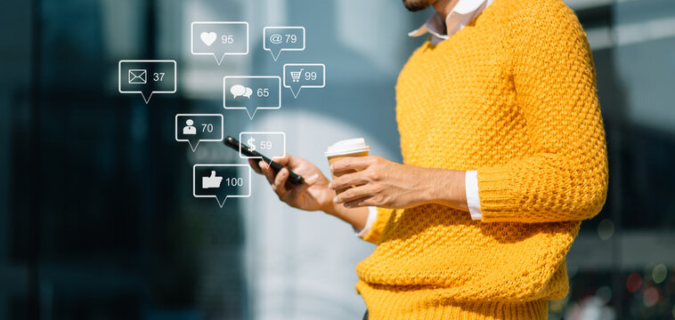 Asian man typing smartphone, keyboard  with laptop computer of.Social media and Marketing virtual icons screen concept.