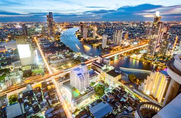 Aerial rooftop view of Bangkok at night, after dusk.