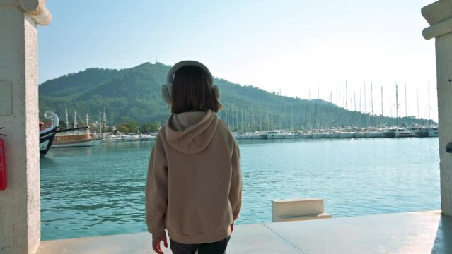 Girl walking and watching the sea port in Kash city in Turkey. 4k footage UHD 3840x2160 
