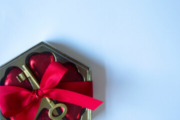 Valentine's photo. of a gift with a red ribbon on a white background leaving free space for text