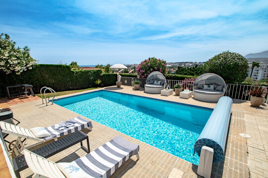 a poolside image inside a luxury chalet with Mediterranean views