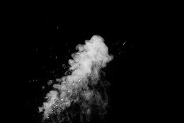 Obraz premium Close-up of white water vapor with water splashes flying in different directions from the humidifier Isolated on a black