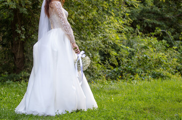 Girl in a wedding dress in nature.