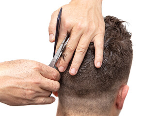 Obraz premium The barber cuts a man's haircut with scissors
