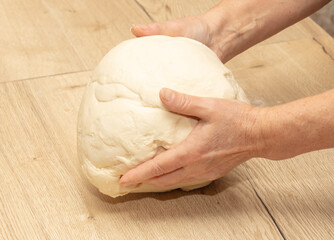 Hand kneading flour dough.