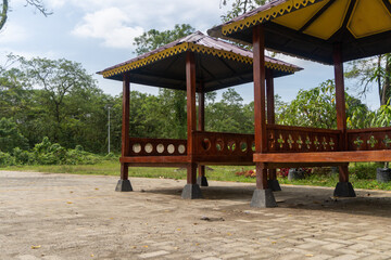 Fototapeta na wymiar Wooden gazebo to relax in the middle of a city park