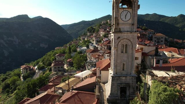 Aerial video by drone of the historical clock tower of Dimitsana with the traditional houses in Arcadia, Peloponnese, Greece