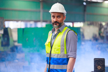 Portrait Caucasian professional Engineer factory. Engineering worker in safety hardhat at factory...