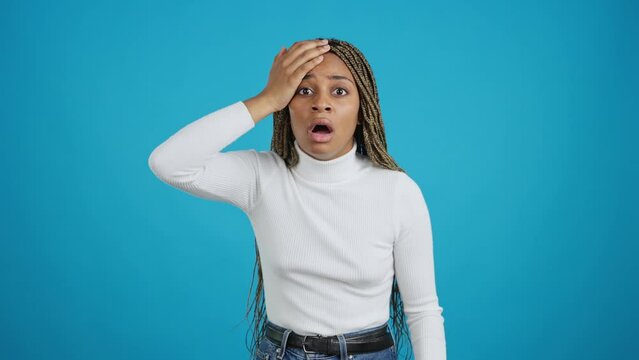 Forgetful african woman gesturing a mistake with the hand