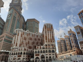 A beautiful daytime view of the Mecca Clock Tower in front of the Grand Mosque in Mecca, Saudi Arabia.