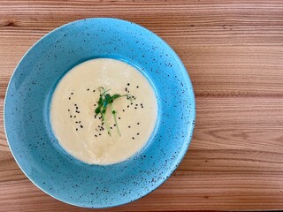 Bowl of creamy potato soup on wooden plate Greek traditional cuisine Tzatziki with cucmber and dill. High quality photo