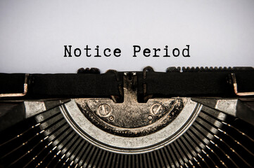 Notice period text typed on an old vintage typewriter. Employment and termination concept