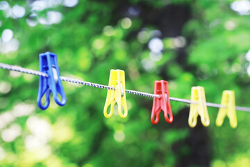 Dry clothes outside. Clothes on a rope. Clothespins on a clothesline in summer.