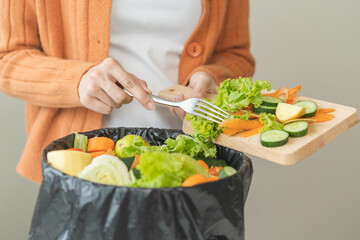 Compost from leftover food, asian young housekeeper woman hand holding cutting board use fork...