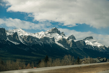 Scenic road through the Canadian Rockies, surrounded with rocky mountains. Taken in Banff National Park, Alberta, Canada