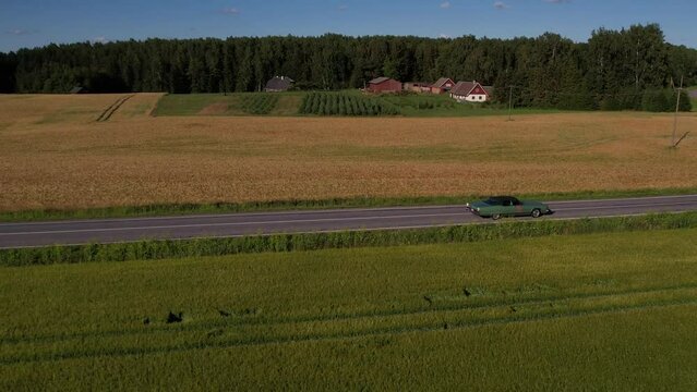 Tartu, Estonia - 13.07.2022 - Old 70's historic and unique car driving on green landscapes and roads.