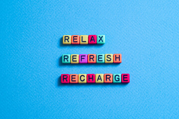 Relax,Refresh,Recharge - word concept on cubes, text