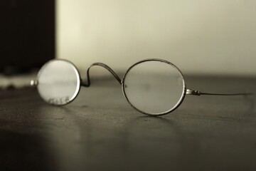 Aged Dusty Eyeglasses on a Wooden Table