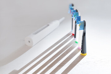 Electrical tooth brushes set in sunny day on white background.
