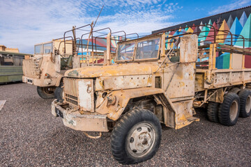 Abandoned and rusty military vehicles in the middle of the desert