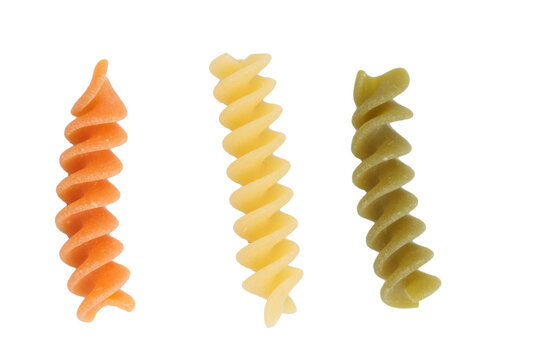 Three samples of different colors of fusilli pasta.