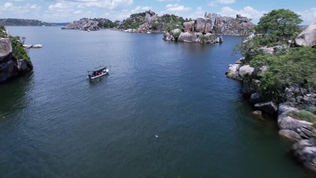 The city of big rocks. Mwanza, Tanzania located next to lake Victoria. Aerial drone footage showing boat sailing on the lake in a beautiful landscape in Africa