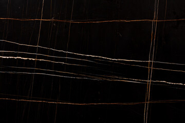Sahara Noir Marble background, top texture for effect dark design look. Slab photo. Dark black matt...