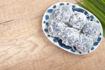 Kanom Ko or sugar dumplings in Sweet Coconut Milk mixed with coconut