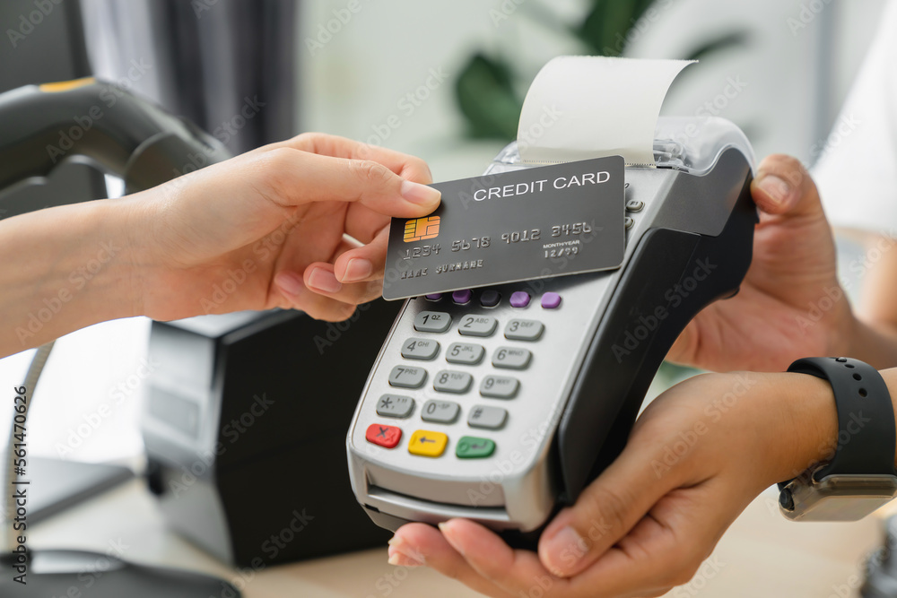 Poster customer using credit card for payment by nfc technology on card reader machine to owner at restaura