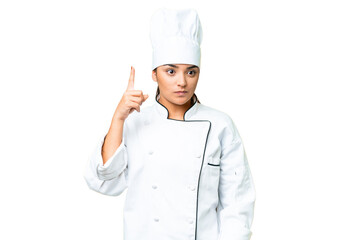 Young woman Chef over isolated chroma key background pointing with the index finger a great idea