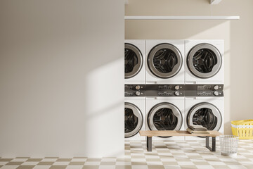 Light laundry interior with washing machines in row and bench. Mockup wall - obrazy, fototapety, plakaty