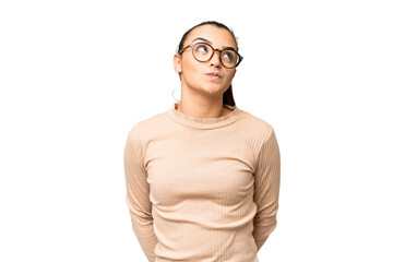 Young beauty woman over isolated chroma key background and looking up