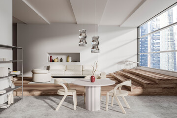 Light living room interior with eating table and couch, panoramic window