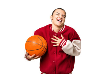 Young Woman playing basketball over isolated chroma key background smiling a lot