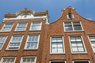 Fototapeta na wymiar Two Amsterdam houses with blue sky in the background. Netherlands.
