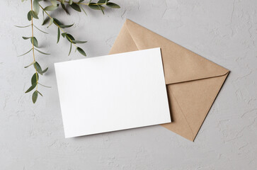 Invitation or greeting card mockup with envelope and green eucalyptus
