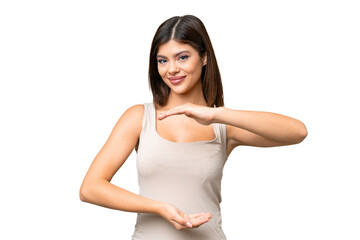 Young Russian woman over isolated chroma key background holding copyspace imaginary on the palm to insert an ad
