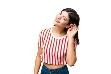 Naklejka premium Young Russian woman over isolated chroma key background listening to something by putting hand on the ear