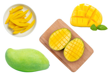 Top view of yellow exotic fresh mango slices on a wooden kitchen board on checked tablecloth and green surface