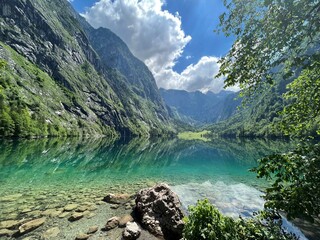 Water reflection in Obersee and mountains at Koenigssee in Berchtesgaden National Park in Germany