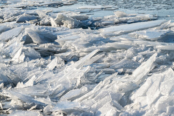 Broken sharp hummock ice floes in the frozen sea.  Chunks of drifting ice near the coast of IJsselmeer in Almere during cold winter weather in the Netherlands. Icy background macro. © O de R