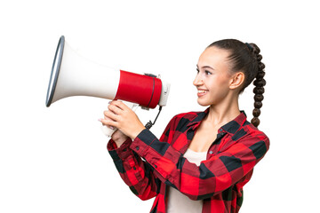 Young Arab woman over isolated background shouting through a megaphone to announce something