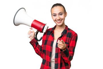 Young Arab woman over isolated background holding a megaphone and smiling while pointing to the front
