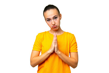 Young Arab woman over isolated background keeps palm together. Person asks for something