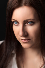 Obraz premium Portrait of Caucasian ethnicity adult woman forty years old. Beautiful female human face of brunette with gray eyes. Soft selective focus, deep-of-field of eyes.