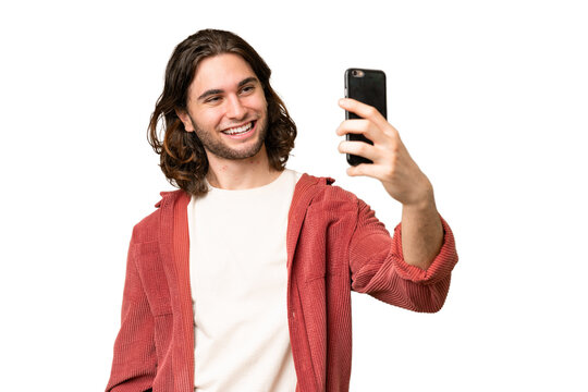 Young handsome man over isolated background making a selfie
