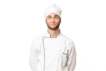 Young handsome chef man over isolated background and looking up