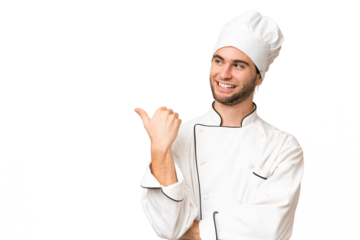 Young handsome chef man over isolated background pointing to the side to present a product