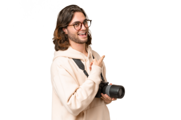 Young photographer man over isolated background pointing back